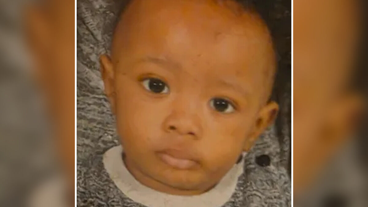 Close-up of toddler with dark eyes wearing a gray sweater, related to vegan diet signs the woman ignored.