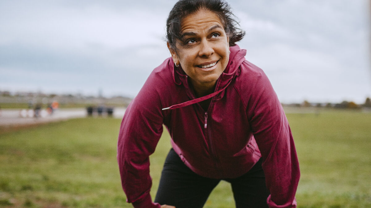 Middle-aged woman outdoors exercising, illustrating the critical point when your body starts to age rapidly.