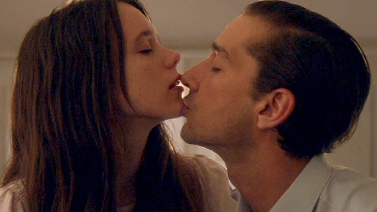 Two movie stars sharing an intimate moment while filming love-making scenes in a close-up romantic setting.