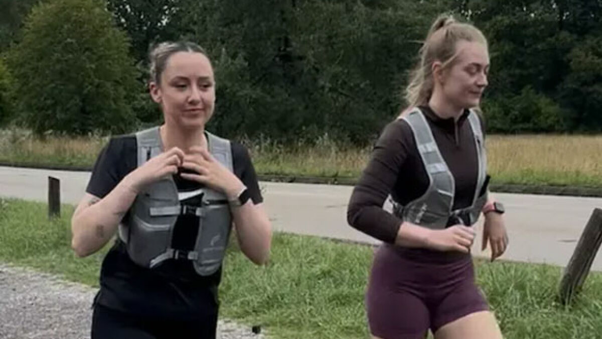 Two cops wearing running clothes and safety vests jogging outdoors as part of an undercover catcall sting operation