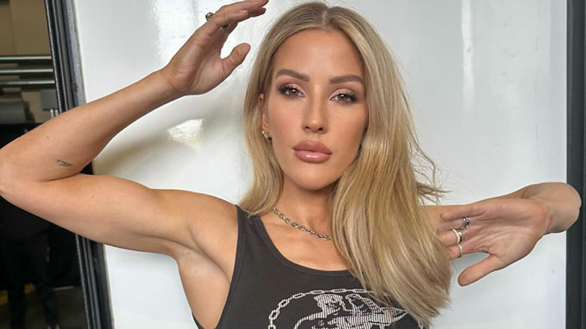 Ellie Goulding posing confidently in a sleeveless top, sharing a racy selfie amid romance rumors and fan reactions.