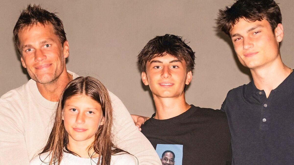 Tom Brady posing with children indoors, highlighting family tensions and Gisele Bu00fcndchen furious over parenting jabs.