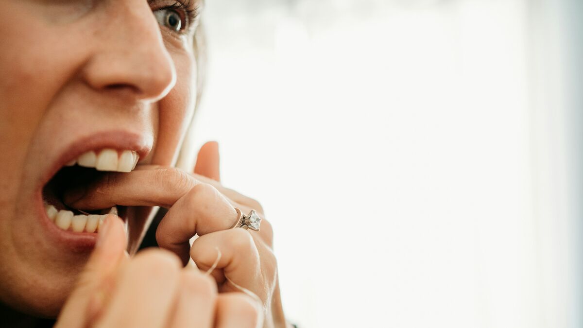 Close-up of person flossing teeth, illustrating a tiny habit that could help prevent heart attack and dementia.