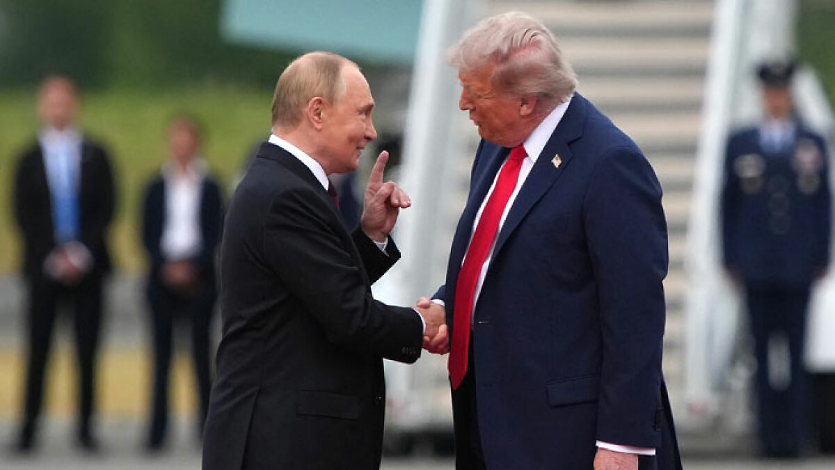 Trump and Putin share an awkward handshake during historic meeting with body language experts analyzing their interaction.