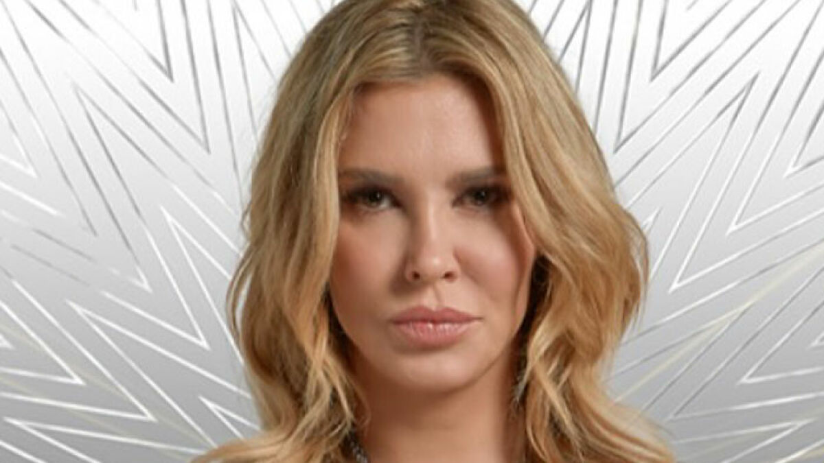 Brandi Glanville with blonde hair and natural makeup showcasing her new smile after health battle and parasite recovery.