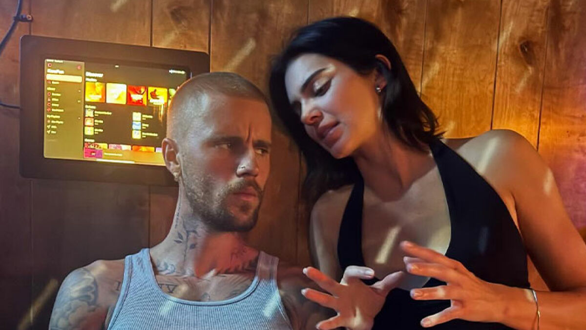 Justin Bieber and Kendall Jenner in a cozy dive bar setting, sparking buzz with Hailey Bieber's witty comment.