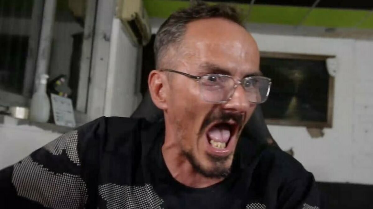 Man with glasses and beard shouting intensely during a live stream, capturing a famous streamer moment.