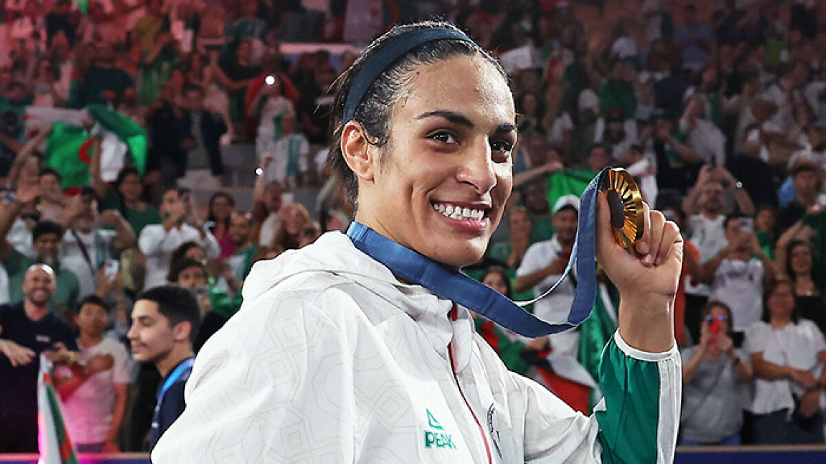 Imane Khelif smiling and holding a medal, showcasing her dramatic makeover after Paris Olympics gender controversy.
