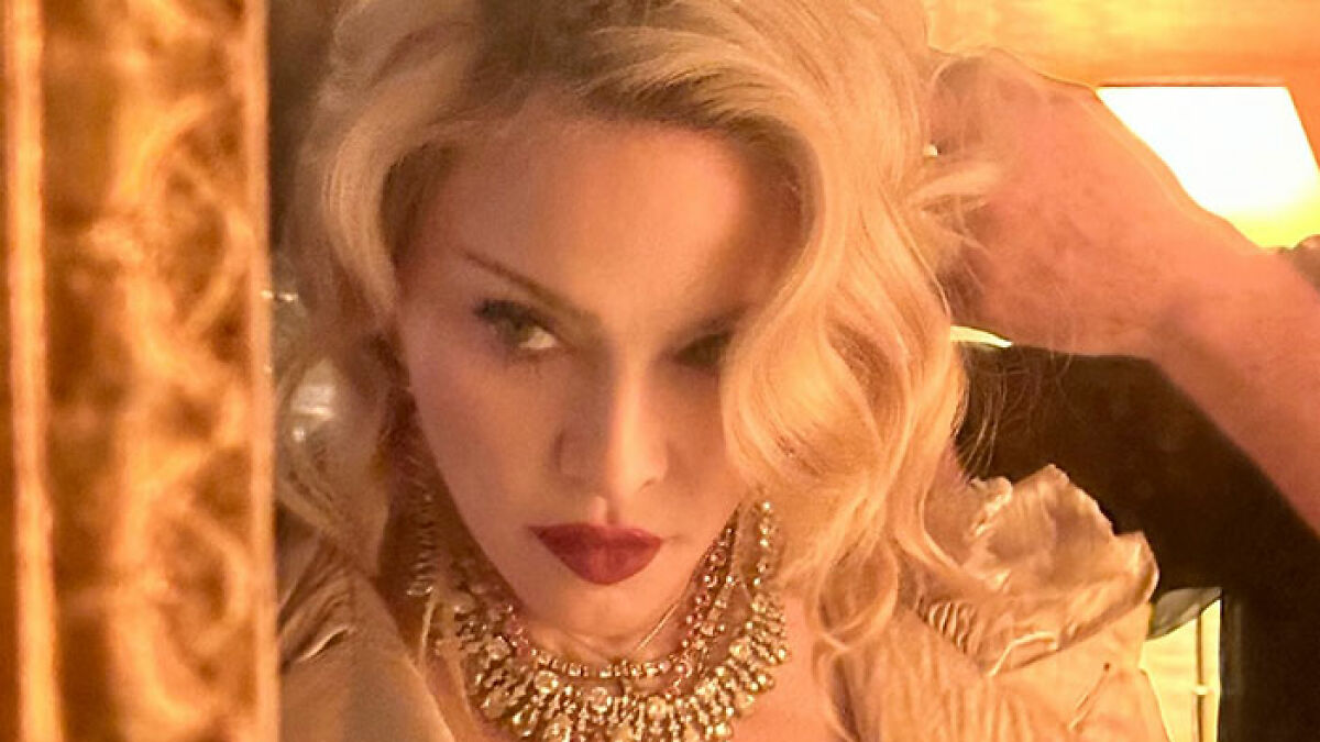 Madonna's daughter Lourdes with blonde hair and red lipstick at a birthday party, possibly experiencing a nip slip.