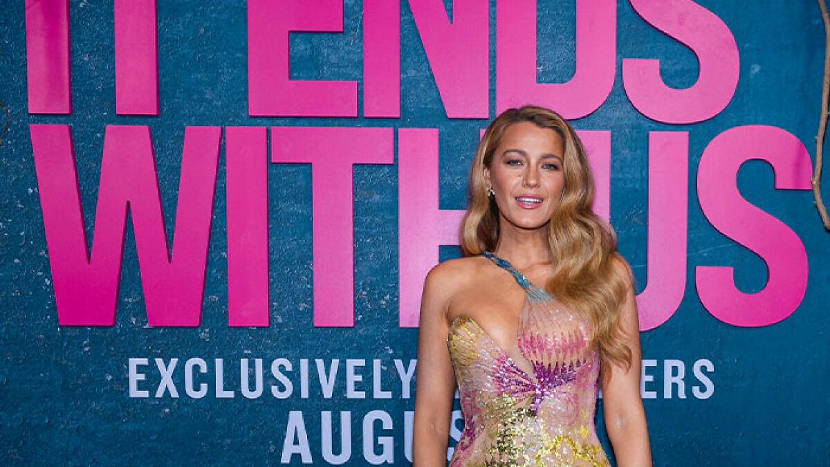 Blake Lively posing at a movie premiere event, wearing a colorful dress, linked to new rom-com leading role news.