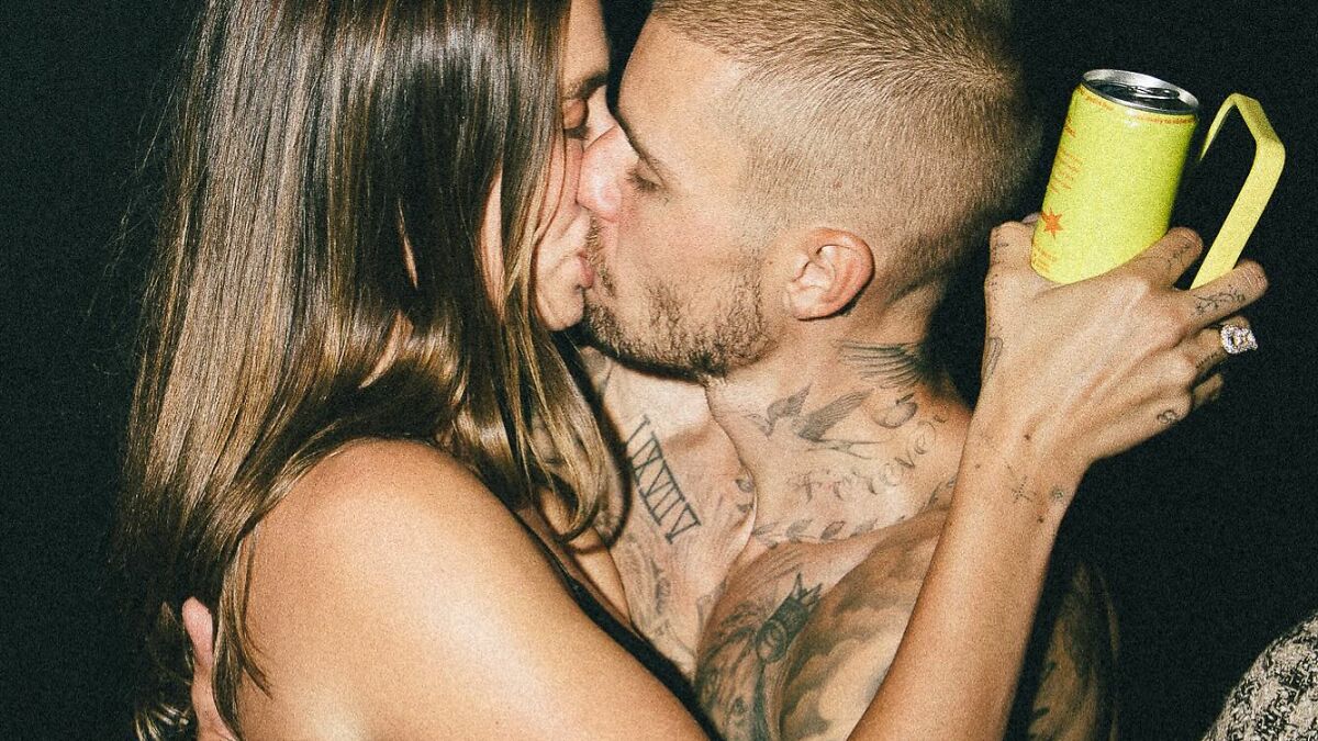 Justin and Hailey Bieber sharing a close moment amid discussions of their troubled marriage and new album success.