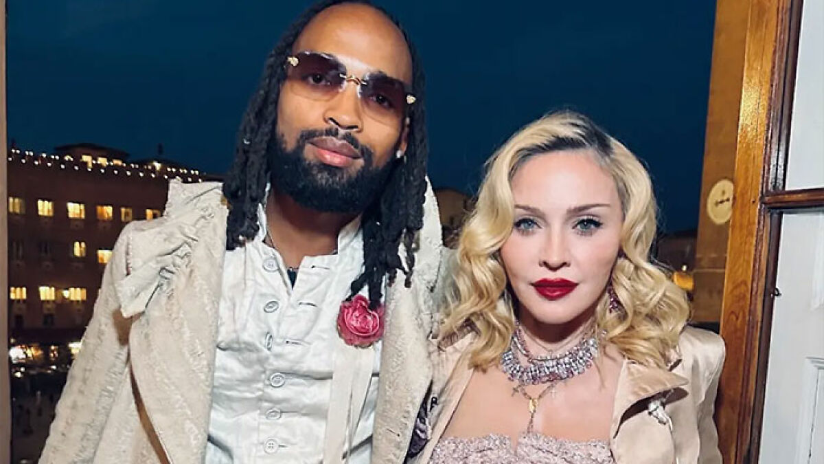 Madonna with her 29-year-old boyfriend, wearing stylish outfits at a nighttime event, following cosmetic change advice.