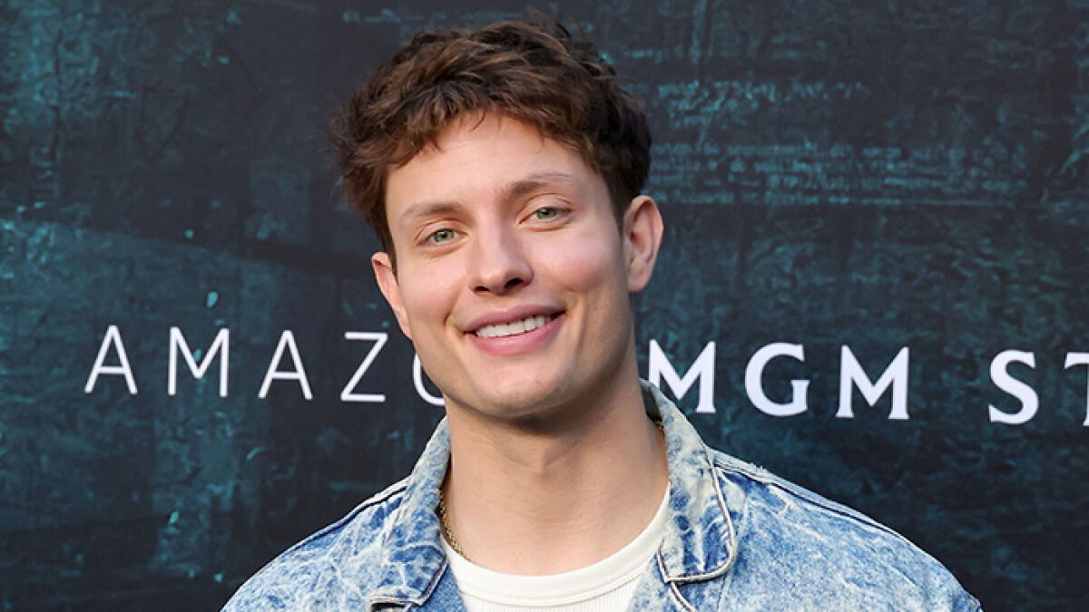 Comedian Matt Rife smiling at an event, wearing a denim jacket, supporting Sydney Sweeney amid viral ad backlash.