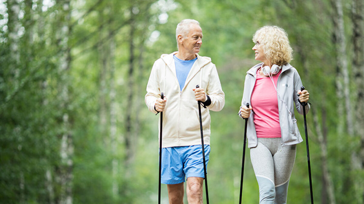 Older couple practicing the viral 6-6-6 walking trend in a forest, promoting fat-burning results without burnout.