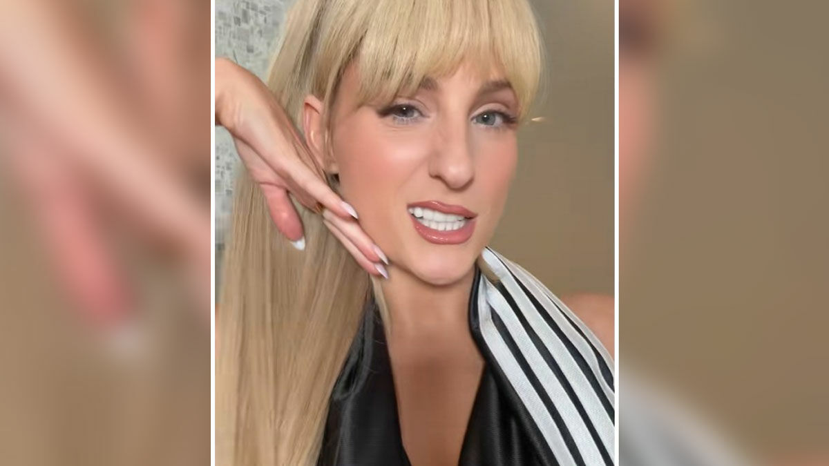 Meghan Trainor posing with long blonde hair and striped outfit after being unrecognizable and mistaken for Paris Hilton