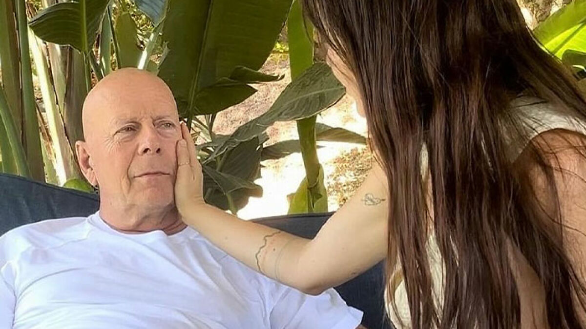Bruce Willis and wife sharing a tender moment outdoors as she gives a heartbreaking health update about the actor.