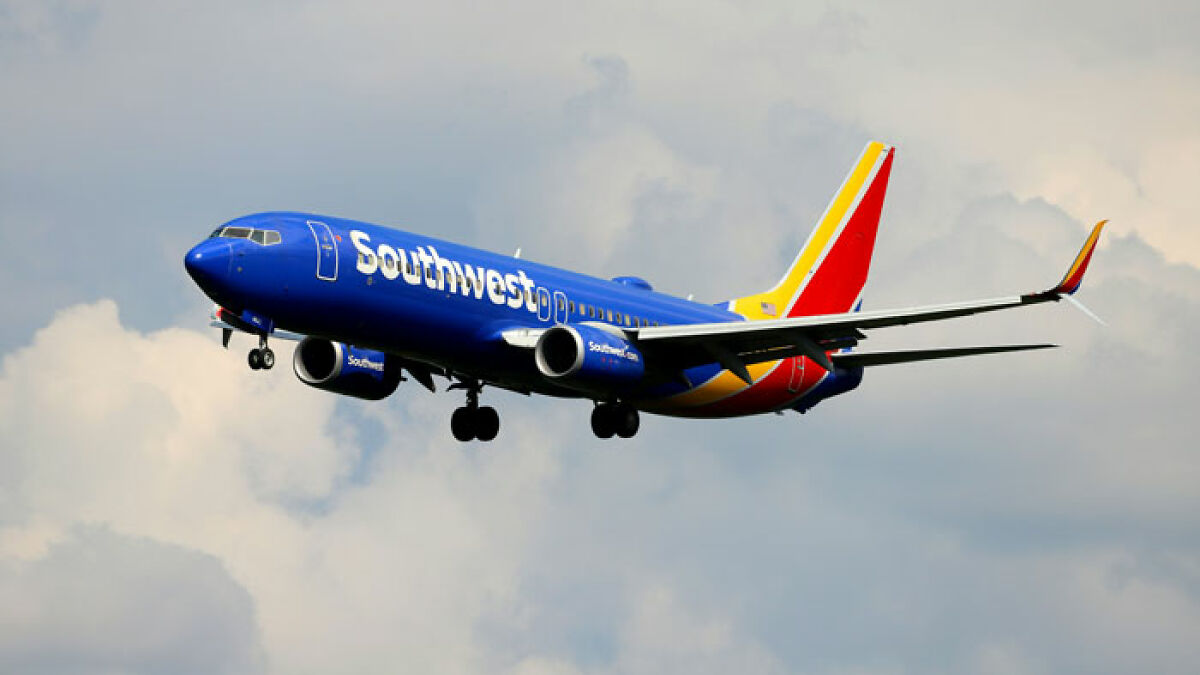 Southwest Airlines airplane in flight, illustrating airline controversy involving new rules for plus-size passengers.