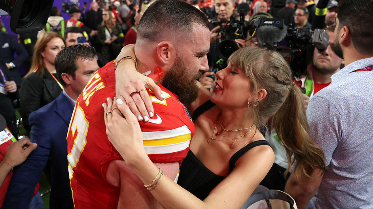 Taylor Swift embracing Travis Kelce on field with media around, related to Bonnie Blue's comment before engagement announcement.