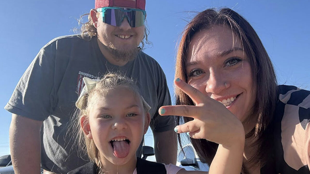 Family smiling outdoors with child, illustrating family awarded nearly a billion dollars after gravely disabled baby case.