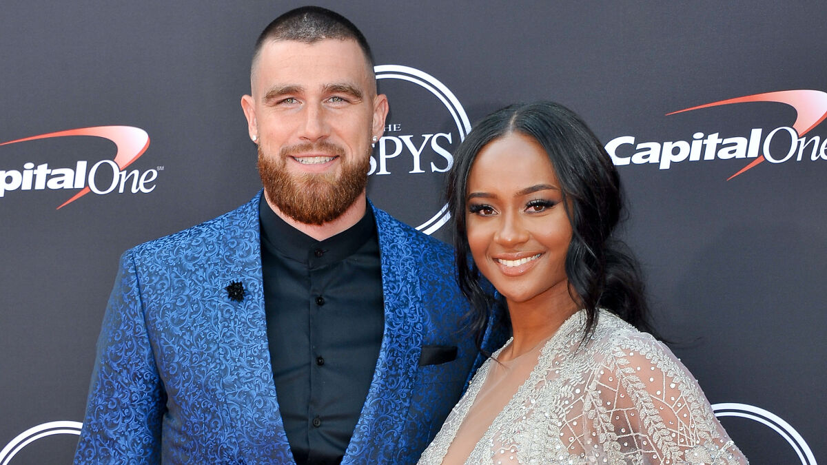 Travis Kelce and Kayla Nicole posing together on the red carpet, sparking buzz after his proposal to Taylor Swift