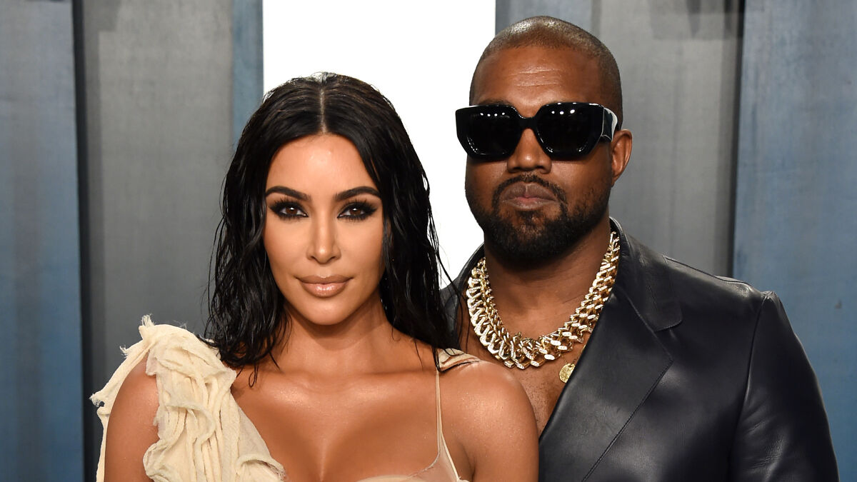 Kim Kardashian and Kanye West posing together at an event, exemplifying celebs publicly called out on social media.