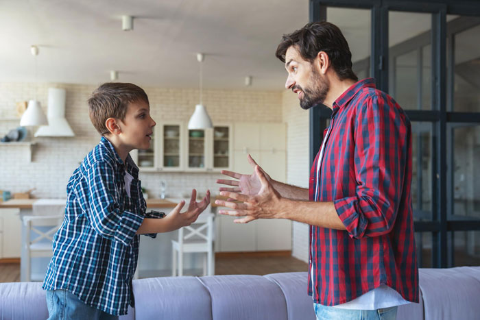 Boy and man having a tense conversation in a living room, illustrating concerns about nephew’s safety and controlling behavior. Boy and man having a tense conversation in a living room, illustrating concerns about nephew’s safety and controlling behavior.
