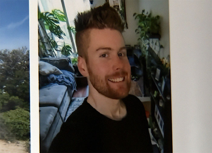 Smiling man with a beard in a black shirt inside a cozy living room, symbolizing good Samaritan protecting helpless mom and children. Smiling man with a beard in a black shirt inside a cozy living room, symbolizing good Samaritan protecting helpless mom and children.