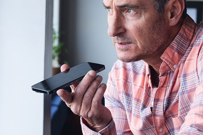 Middle-aged man holding phone near face, appearing serious while calling CPS on teen daughter in a difficult moment. Middle-aged man holding phone near face, appearing serious while calling CPS on teen daughter in a difficult moment.