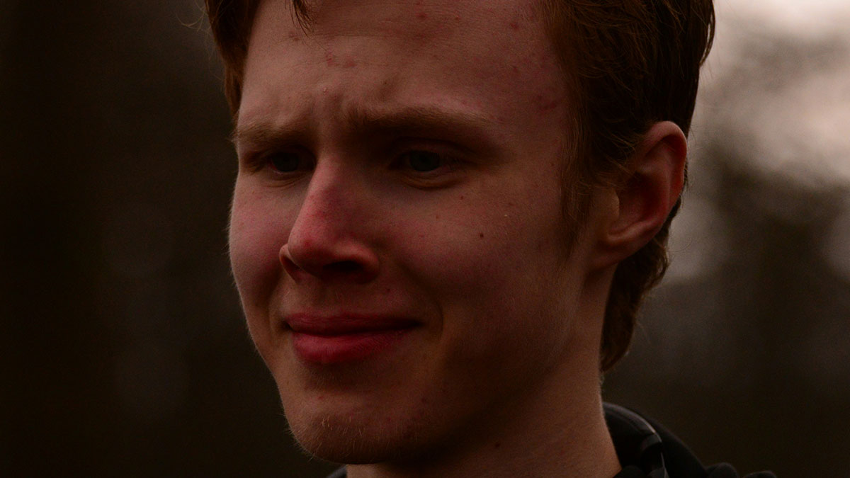 Young man with a troubled expression outdoors, reflecting tension from daughteru2019s 18YO friend coming on to dad situation.