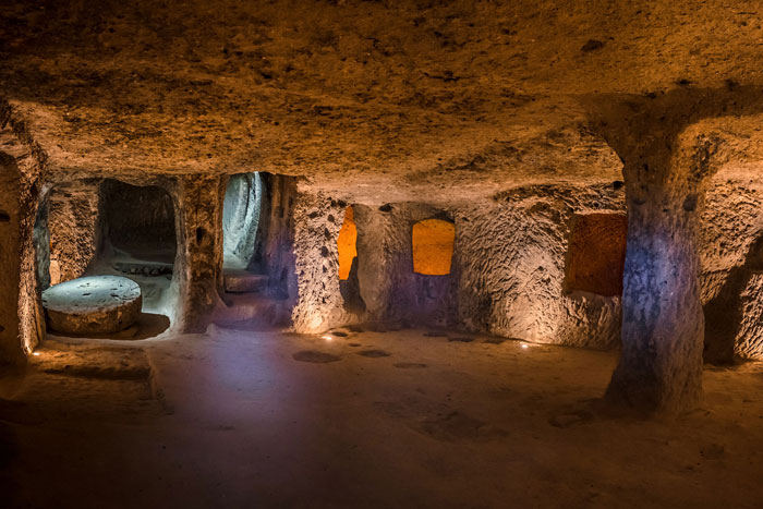 Ancient mysterious underground city 18 stories deep with carved stone pillars and rooms illuminated by soft lights. Ancient mysterious underground city 18 stories deep with carved stone pillars and rooms illuminated by soft lights.