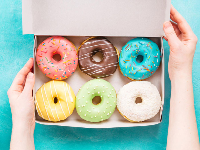 Box of colorful donuts held by hands, representing the revenge served instead of donuts in a parking spot dispute. Box of colorful donuts held by hands, representing the revenge served instead of donuts in a parking spot dispute.