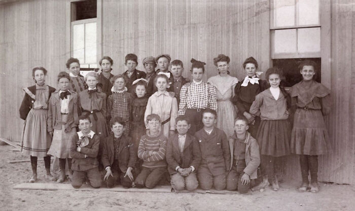 Group of children in early 1900s clothing posing outside a building, capturing the birth of Vegas history.