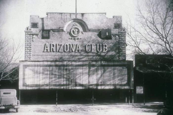 Historic Arizona Club building in early Las Vegas, showcasing the birth of Vegas through vintage architecture and classic cars.
