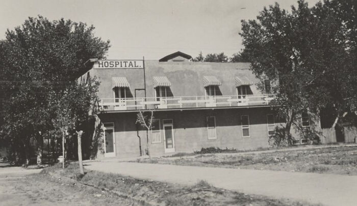 Early historic hospital building surrounded by trees, showcasing the birth of Vegas in the mid-1900s.
