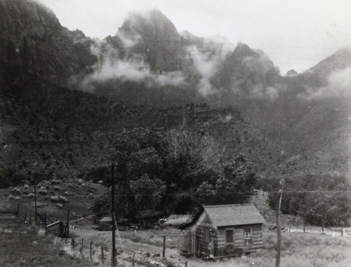 Early Nevada landscape with rustic cabin and mountains shrouded in clouds, capturing the birth of Vegas in historic times.