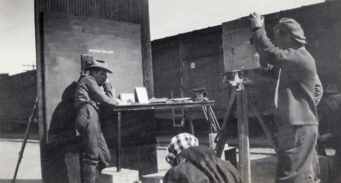 Surveyors working with equipment at a construction site during the birth of Vegas in early historic pictures.