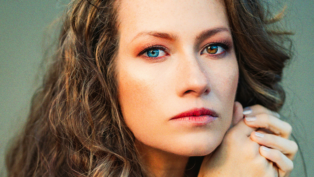 Woman with heterochromia looking serious, highlighting strange and bizarre reasons why someone wanted a divorce.