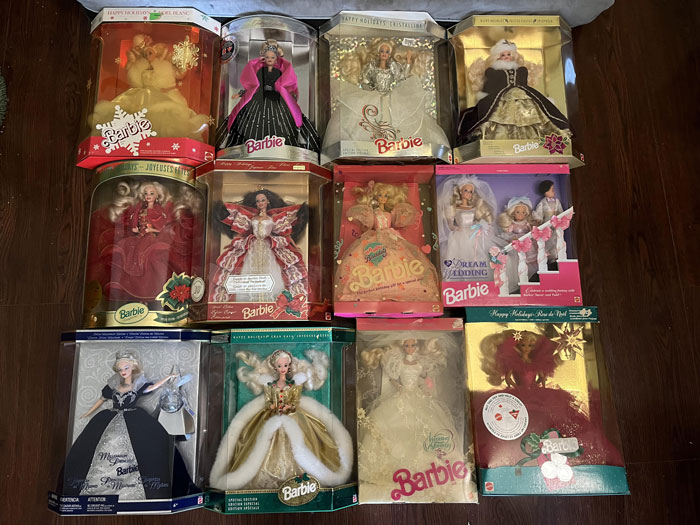 Collector Barbie dolls in original packaging displayed on wooden floor, highlighting valuable collectibles and careful preservation. Collector Barbie dolls in original packaging displayed on wooden floor, highlighting valuable collectibles and careful preservation.