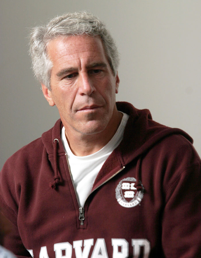 Man in a Harvard sweatshirt looking down thoughtfully, representing doubts about Epstein jail video missing minutes. Man in a Harvard sweatshirt looking down thoughtfully, representing doubts about Epstein jail video missing minutes.
