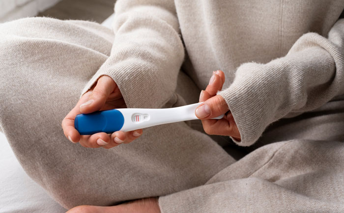 Person holding pregnancy test showing positive result, symbolizing affair pregnancy and tensions with boyfriend and bestie’s partner. Person holding pregnancy test showing positive result, symbolizing affair pregnancy and tensions with boyfriend and bestie’s partner.