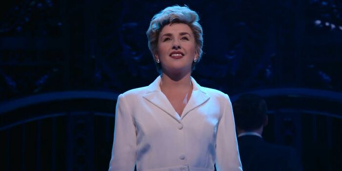 Actress in white blazer on stage with dark background, representing Netflix movies that turned out to be letdowns.