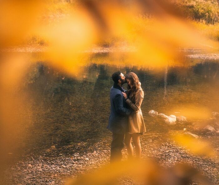 Couple embracing near a riverbank in autumn, representing love and commitment in a fiance non biological child wedding setting. Couple embracing near a riverbank in autumn, representing love and commitment in a fiance non biological child wedding setting.