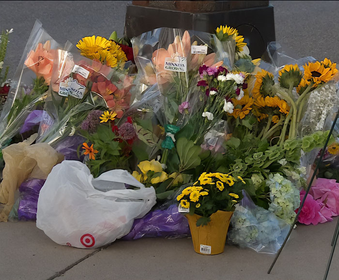 Floral memorial with sunflowers and mixed bouquets placed in tribute related to Minneapolis massacre culprit incident. Floral memorial with sunflowers and mixed bouquets placed in tribute related to Minneapolis massacre culprit incident.