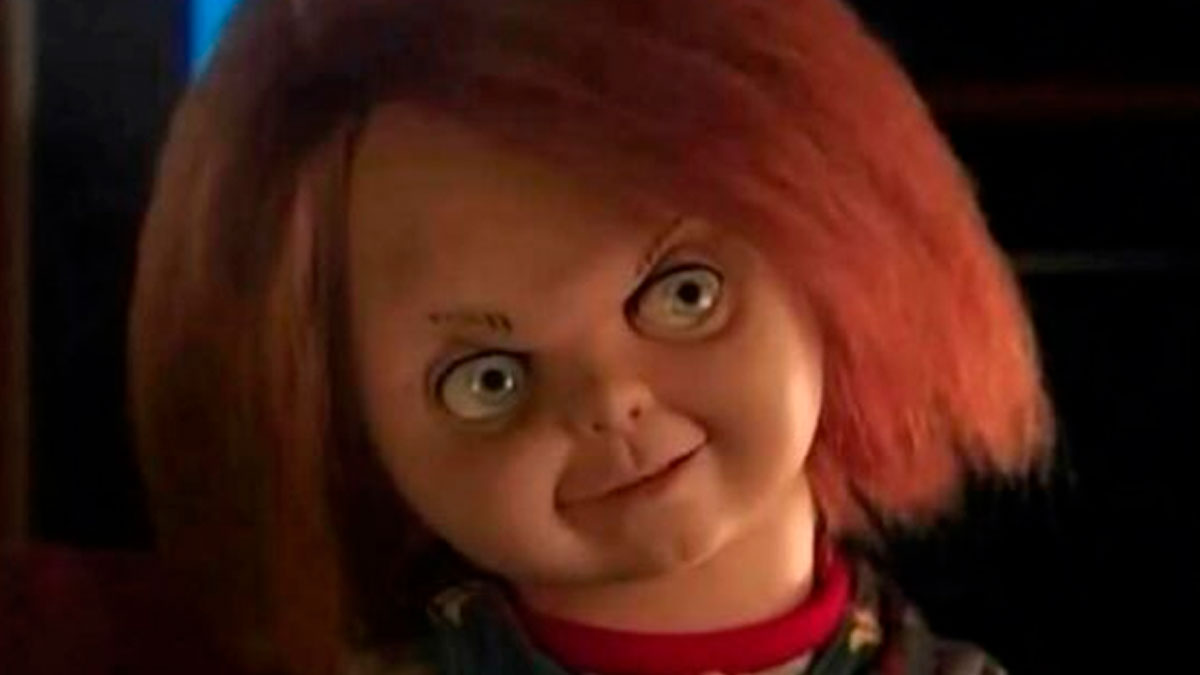 Creepy doll with red hair and wide eyes, featured in hilarious memes for your daily dose of laughter and good vibes.