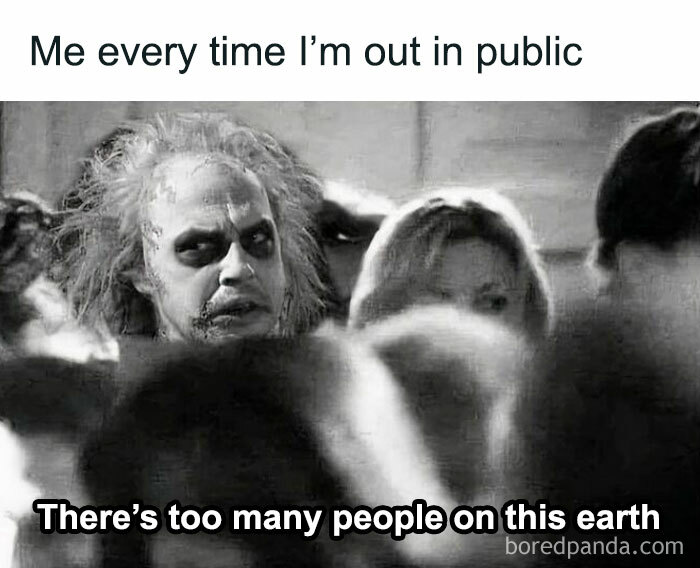 Person with wild hair and makeup looking overwhelmed in a crowd, illustrating neurodivergent relatable social anxiety humor.