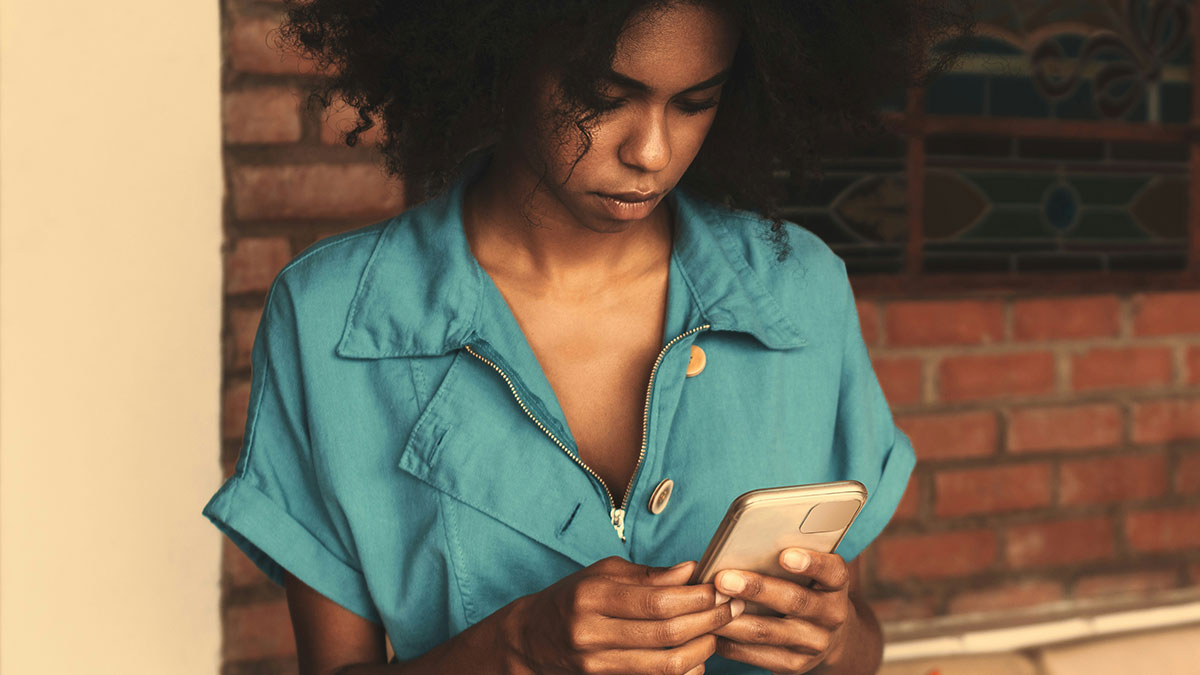 Young woman in a teal jacket using a smartphone, illustrating people saying unique sentences and unusual thoughts.