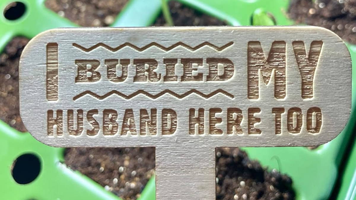Wooden garden marker with humorous text indicating gadgets that make garden less of a chaotic hellscape.