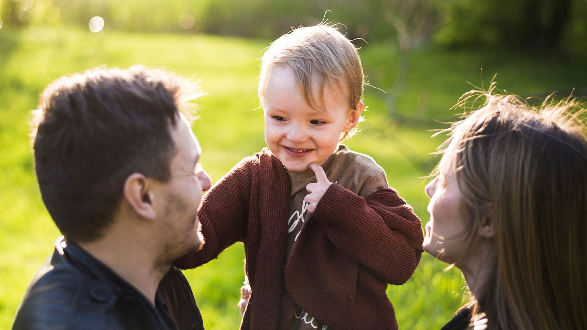 Young child with adults outdoors, reflecting themes of autistic stepbro and future caregiver responsibility.