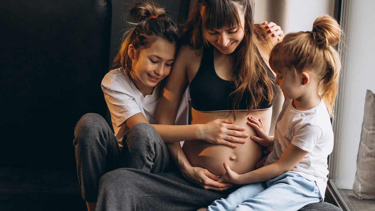 Pregnant lady with two children smiling and touching her belly, highlighting family emotions and neglect concerns.