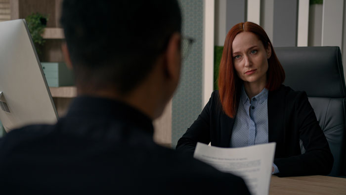 HR manager listening seriously to an employee in an office, addressing toxic behavior and workplace conflicts. HR manager listening seriously to an employee in an office, addressing toxic behavior and workplace conflicts.